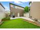 This backyard features low maintenance artificial turf and concrete patio at 18619 E 50Th Pl, Denver, CO 80249