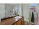 Bathroom featuring a light single sink vanity, toilet, and shower with glass doors at 18619 E 50Th Pl, Denver, CO 80249