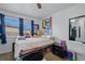 Well-lit bedroom with a large window, neutral walls, and plush carpeting at 18619 E 50Th Pl, Denver, CO 80249