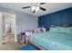 Bedroom featuring neutral colors, a ceiling fan and a large window for natural light at 18619 E 50Th Pl, Denver, CO 80249