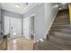 Entryway features neutral colored walls, stairwell and door to the downstairs bathroom at 18619 E 50Th Pl, Denver, CO 80249