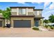 Two-story home featuring brick driveway, attached two-car garage, and colorful front door at 18619 E 50Th Pl, Denver, CO 80249