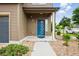 Inviting covered entryway with a blue door, complemented by professional landscaping at 18619 E 50Th Pl, Denver, CO 80249