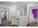 Upstairs hallway with multiple doorways to bedrooms and the bath at 18619 E 50Th Pl, Denver, CO 80249