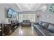 Comfortable living room with hardwood floors, bright windows, and recessed lighting at 18619 E 50Th Pl, Denver, CO 80249