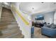 Living room and stairwell featuring modern decor, hardwood floors, and neutral-colored walls at 18619 E 50Th Pl, Denver, CO 80249