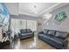 Living room featuring hardwood floors, large windows, and modern lighting fixture at 18619 E 50Th Pl, Denver, CO 80249