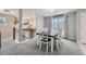 Open dining room with a farmhouse table adjacent to the stairway at 7648 S Sicily Way, Aurora, CO 80016