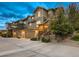 Charming townhome exterior with a two-car garage, stone accents, and well-maintained landscaping at 7648 S Sicily Way, Aurora, CO 80016