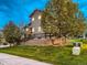 Home exterior showcasing a landscaped backyard, trees, and a multi-level yard at 7648 S Sicily Way, Aurora, CO 80016