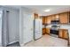 Kitchen with white refrigerator and natural wood cabinetry at 7648 S Sicily Way, Aurora, CO 80016