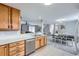 Kitchen area features countertops, stainless steel dishwasher, and natural wood cabinetry at 7648 S Sicily Way, Aurora, CO 80016