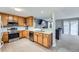 Eat-in kitchen featuring stainless steel appliances and natural wood cabinetry at 7648 S Sicily Way, Aurora, CO 80016