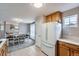 Kitchen and dining area showcasing a modern refrigerator, countertops, and neutral walls at 7648 S Sicily Way, Aurora, CO 80016