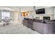 Cozy living room with fireplace, adjacent dining area, and open view to the kitchen at 7648 S Sicily Way, Aurora, CO 80016