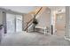 Bright, open living room with plush carpeting, and stairs leading to the second floor at 7648 S Sicily Way, Aurora, CO 80016