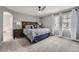 Comfortable main bedroom features a ceiling fan and a large window with natural light at 7648 S Sicily Way, Aurora, CO 80016