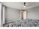 Bedroom with gray walls, ceiling fan, and a patterned comforter on the bed at 7648 S Sicily Way, Aurora, CO 80016