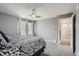 Bedroom with large windows providing natural light and entry to the hallway at 7648 S Sicily Way, Aurora, CO 80016