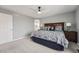 Relaxing main bedroom with attached bathroom and large wood headboard on bed at 7648 S Sicily Way, Aurora, CO 80016