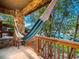 Inviting porch with hammock, stone pillars, wood railings, and view of the neighborhood at 7648 S Sicily Way, Aurora, CO 80016