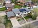 Aerial view of split level house showing a backyard, solar panels, landscaping, and trees at 11165 W 58Th Ave, Arvada, CO 80002
