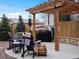 Cozy backyard with pergola, grill, seating, and string lights for outdoor living at 11165 W 58Th Ave, Arvada, CO 80002
