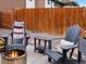 Relaxing backyard features comfortable Adirondack chairs around a modern fire pit at 11165 W 58Th Ave, Arvada, CO 80002