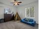 Bright bedroom with a teepee and a blue mini couch at 11165 W 58Th Ave, Arvada, CO 80002
