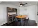 Dining room with a table, chairs, hutch with decor, and dark wood floors at 11165 W 58Th Ave, Arvada, CO 80002