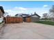 Wide driveway with backyard access, surrounded by a wooden fence at 11165 W 58Th Ave, Arvada, CO 80002