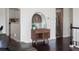Entryway decor with a cabinet, wicker lamp, mirror, and wood floors at 11165 W 58Th Ave, Arvada, CO 80002