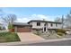 Split level home with two car garage, muted colors, landscaping, and driveway at 11165 W 58Th Ave, Arvada, CO 80002