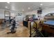 An open garage featuring recreational workout equipment, a black leather couch, and space for all sorts of hobbies at 11165 W 58Th Ave, Arvada, CO 80002