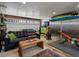 Versatile garage with a black sofa, workout equipment, and storage space, perfect for hobbies and fitness at 11165 W 58Th Ave, Arvada, CO 80002
