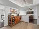 Spacious kitchen with a wooden island, tile flooring, and modern lighting at 11165 W 58Th Ave, Arvada, CO 80002