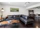 Open living area with a leather couch, decor, and an adjacent dining room at 11165 W 58Th Ave, Arvada, CO 80002