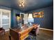 A well lit and decorated office with a large desk, decorational lighting and decorations and modern features at 11165 W 58Th Ave, Arvada, CO 80002