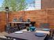 Charming backyard patio with a dining set, outdoor heater, and a wooden fence, perfect for entertaining at 11165 W 58Th Ave, Arvada, CO 80002