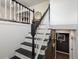 Contemporary staircase with black steps and white railings showing an open upstairs area at 11165 W 58Th Ave, Arvada, CO 80002