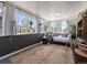Cozy sunroom featuring wicker furniture, hanging plants, and natural light at 11165 W 58Th Ave, Arvada, CO 80002