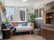 Comfortable sunroom featuring wicker furniture, hanging plants, and patterned rug at 11165 W 58Th Ave, Arvada, CO 80002