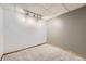 Finished basement with gray carpet, track lighting, and flexible open space at 7721 S Curtice Way # B, Littleton, CO 80120