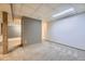 Unfinished basement with concrete floor and ceiling tiles offers room for customization at 7721 S Curtice Way # B, Littleton, CO 80120