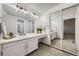 Light and bright bathroom with a vanity, large mirror, and plenty of counter space at 7721 S Curtice Way # B, Littleton, CO 80120