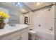 Well-lit bathroom features a white vanity, tiled shower, and a large mirror at 7721 S Curtice Way # B, Littleton, CO 80120