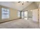 Large bedroom featuring vaulted ceilings, large windows, carpet, and ensuite bathroom at 7721 S Curtice Way # B, Littleton, CO 80120