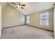 Large bedroom with vaulted ceilings, neutral carpet, and natural light from the windows at 7721 S Curtice Way # B, Littleton, CO 80120