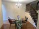 Cozy dining area features a modern chandelier, wood floors and staircase in a comfortable setting at 7721 S Curtice Way # B, Littleton, CO 80120