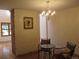 Cozy dining area with hardwood floors, a decorative brick wall, and an elegant chandelier at 7721 S Curtice Way # B, Littleton, CO 80120